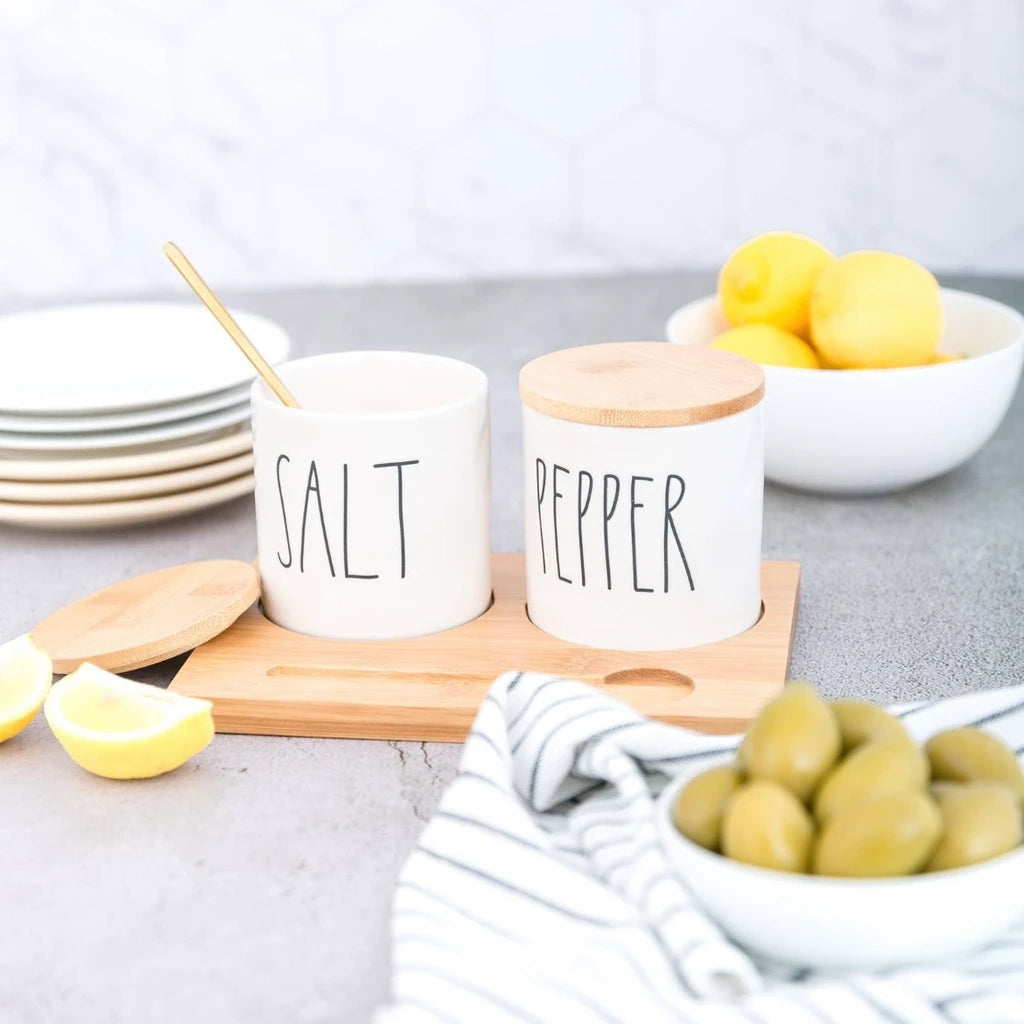 Rae Dunn salt and pepper shakers on bamboo tray